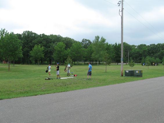 Three people playing disc golf
