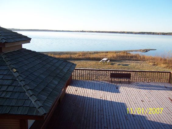 Image from second floor of wooden deck and lake