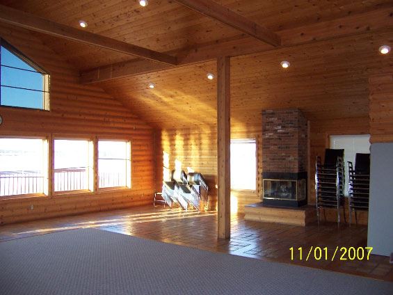 Fireplace and large window in interior room